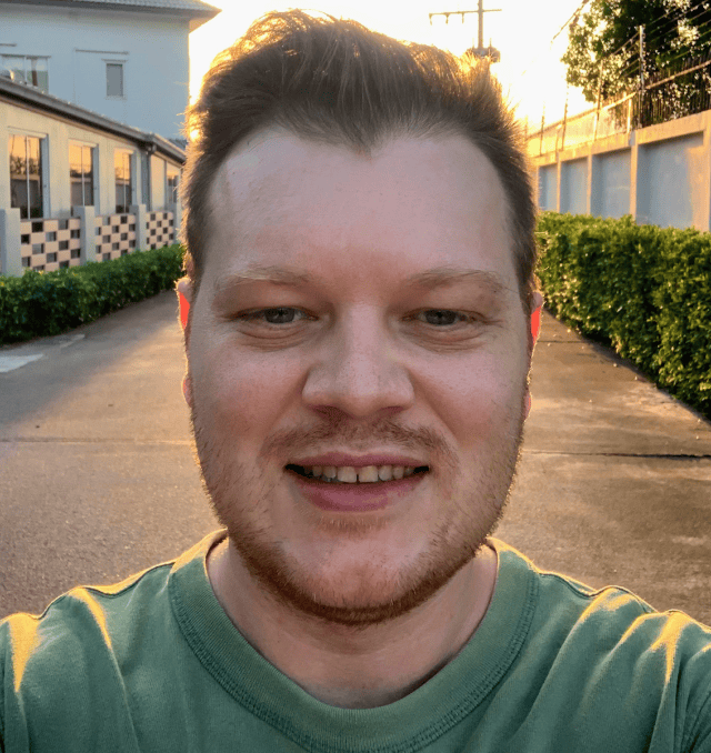 Smiling man with sunset in suburban setting